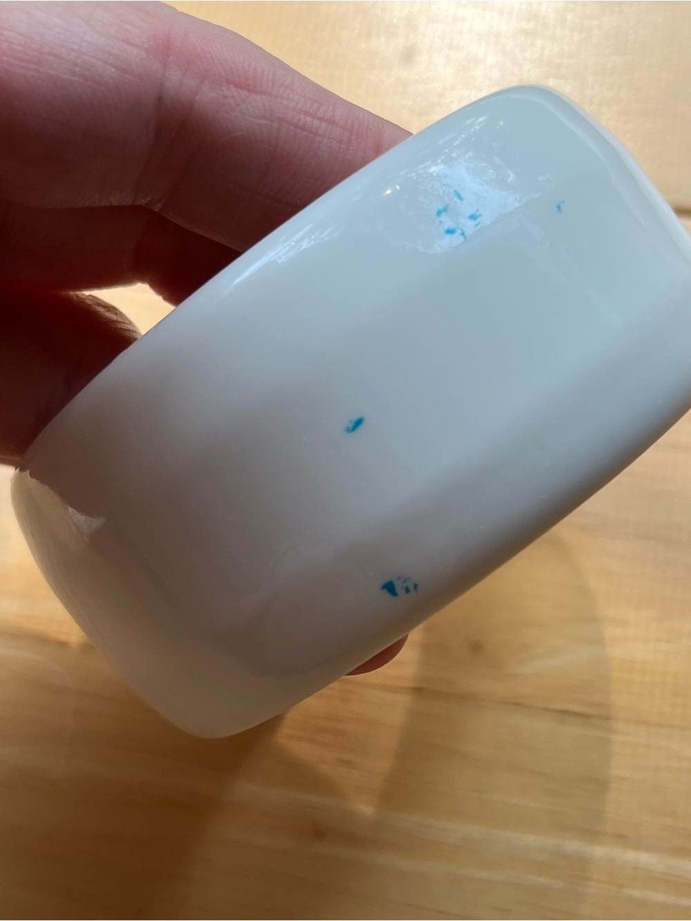 Heavy white plastic bangle with blue accents